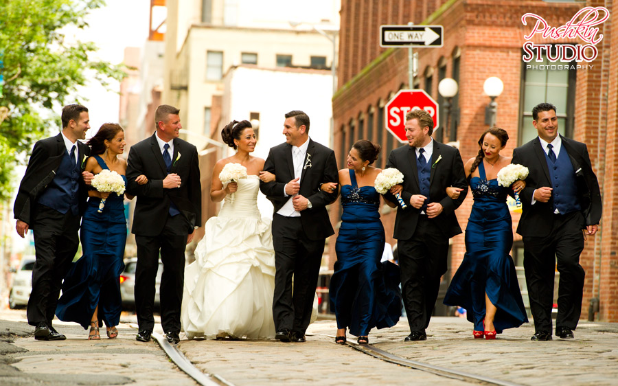 Bride, groom, and bridal party walking in Dumbo